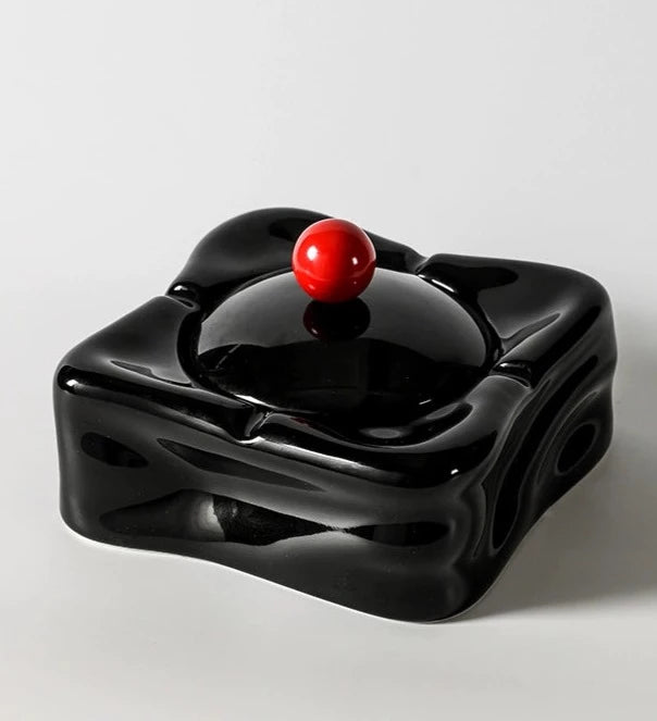 Foresta Ceramic Ashtray with cute ball detail, irregular shape, and modern design. Available in various colorways, choose between lidded or lidless options to suit your style. Crafted from high-quality ceramic for a sleek and contemporary smoking accessory.