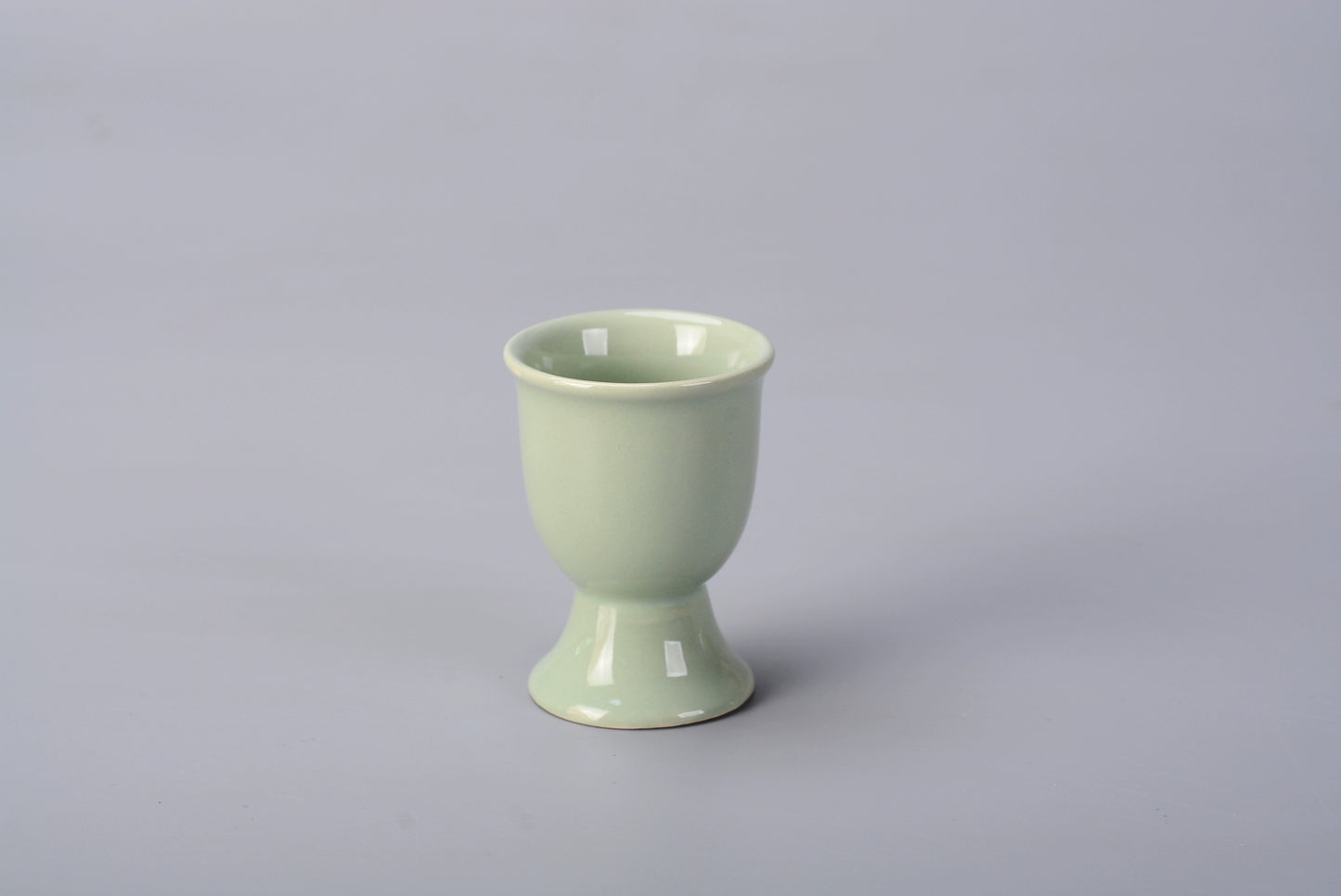 Stylish ceramic egg cup for drippy or hard-boiled eggs - vibrant colors, durable design. Perfect breakfast accessory.