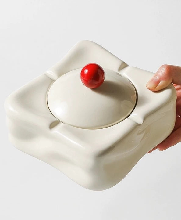 Foresta Ceramic Ashtray with cute ball detail, irregular shape, and modern design. Available in various colorways, choose between lidded or lidless options to suit your style. Crafted from high-quality ceramic for a sleek and contemporary smoking accessory.