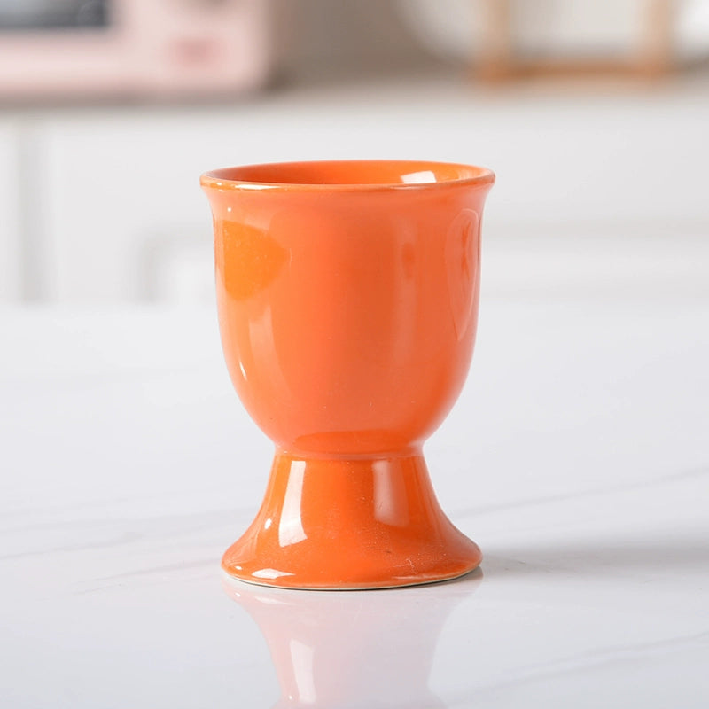 Stylish ceramic egg cup for drippy or hard-boiled eggs - vibrant colors, durable design. Perfect breakfast accessory.