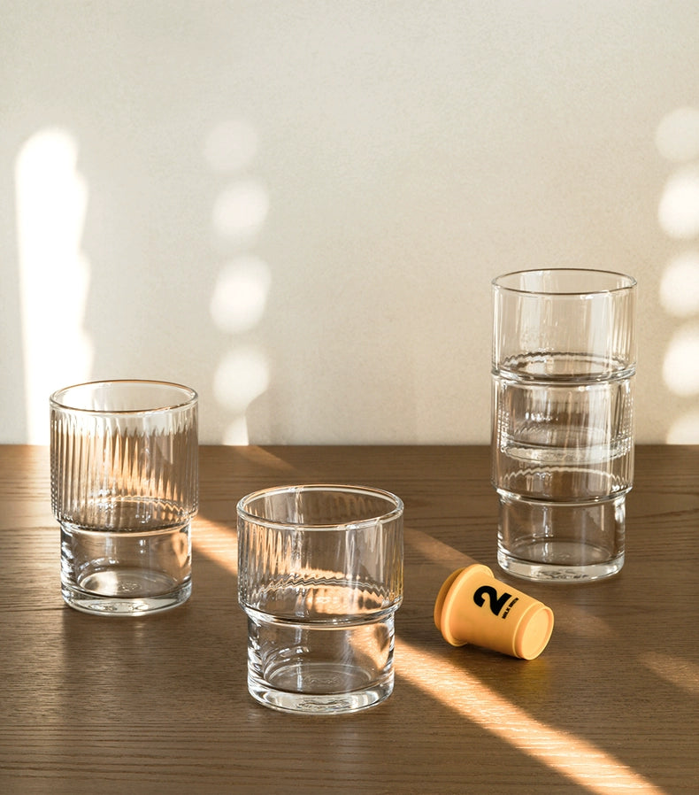 A set of Lyle Stackable Glasses, featuring sleek and minimalistic design. The glasses are crafted from high-quality, clear glass and are stackable for easy storage. Each glass holds 12 ounces, making them ideal for everyday use or entertaining. Perfect for home décor enthusiasts looking to add functional and stylish glassware to their kitchen or dining space.