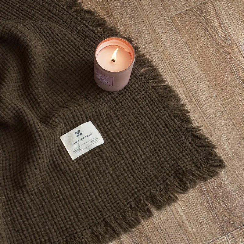 Nogu Throw Blanket – soft Maillard cotton throw with a layered gauze texture, fringe detail, and chic muted colorways, available in two sizes for cozy, stylish comfort.