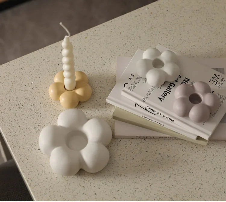 Modern ceramic Uchi candle holder in flower shape, available in various colorways, perfect for small or large candles.