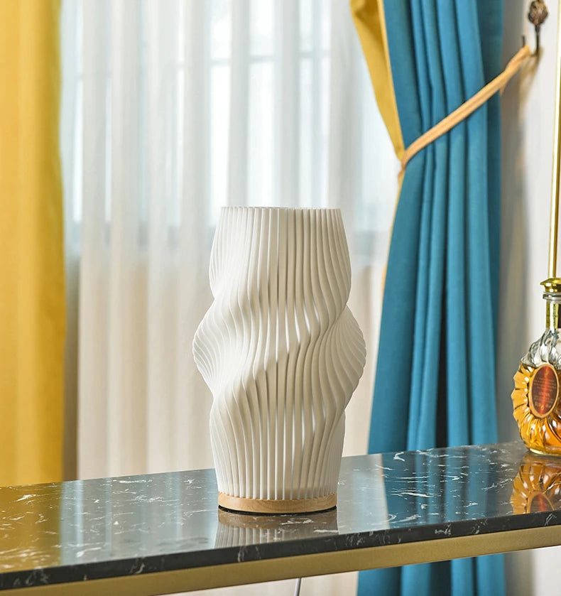 Nogu Table Lamp: Modern table lamp with organic shape, pleated plastic shade, perfect for desks and ambient light. Shop now.