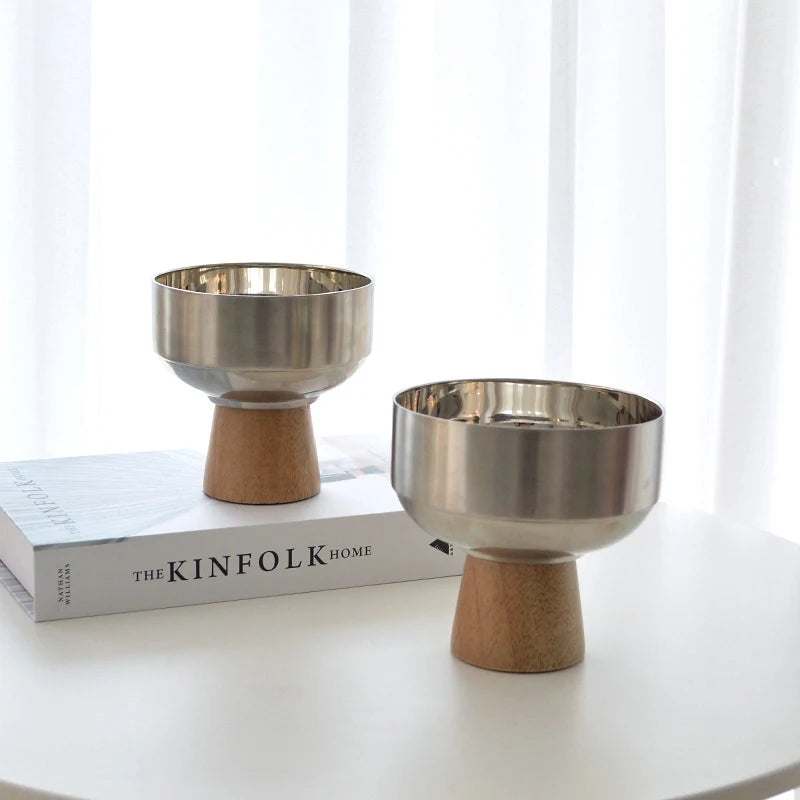 Eddard Serving Bowl featuring a modern design with a sleek stainless steel bowl and a sturdy wooden base. Compact and stylish, this small serving bowl is perfect for home decor enthusiasts looking to add a chic touch to their kitchen or coffee table. Ideal for serving snacks, fruits, or side dishes.