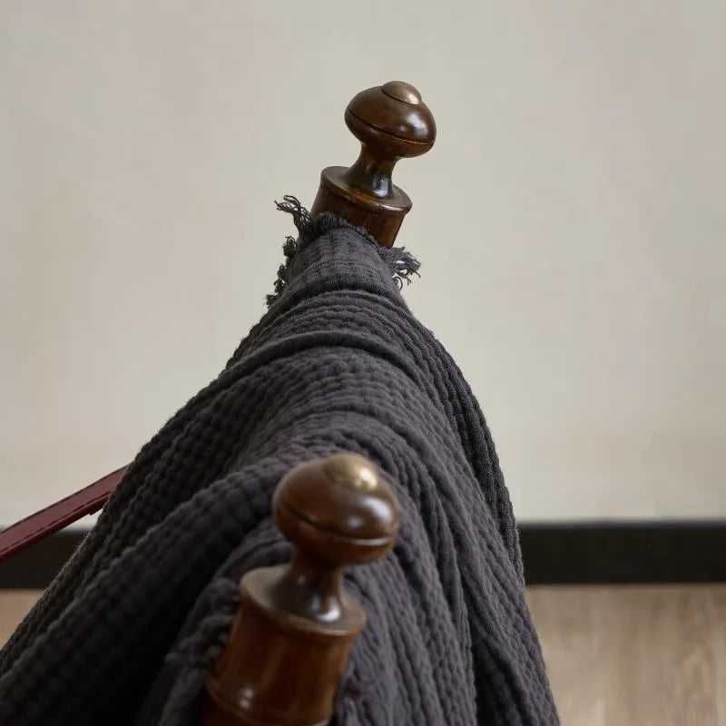 Nogu Throw Blanket – soft Maillard cotton throw with a layered gauze texture, fringe detail, and chic muted colorways, available in two sizes for cozy, stylish comfort.