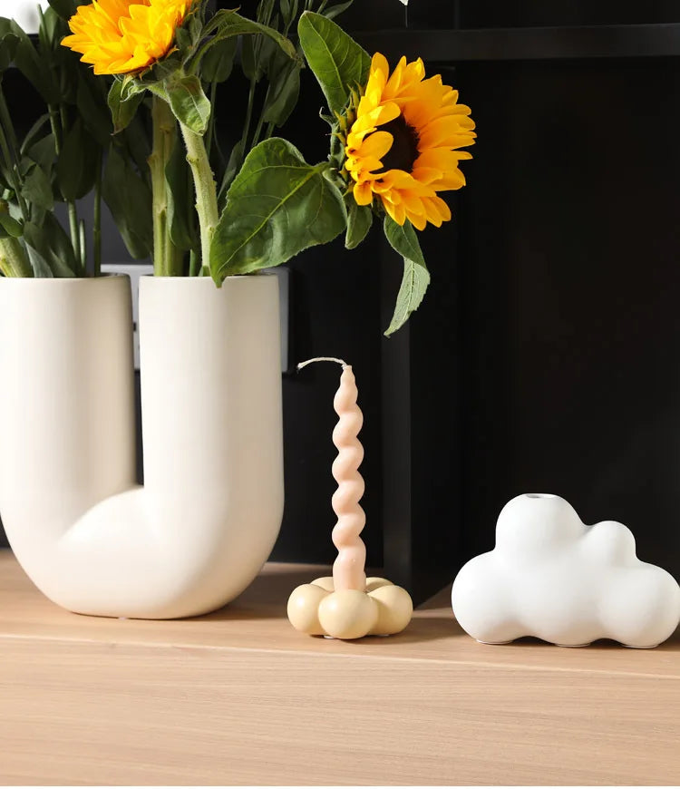 Modern ceramic Uchi candle holder in flower shape, available in various colorways, perfect for small or large candles.