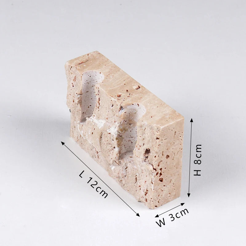 Brutalist candle holder with marble or travertine, anti-slip padding for stability.