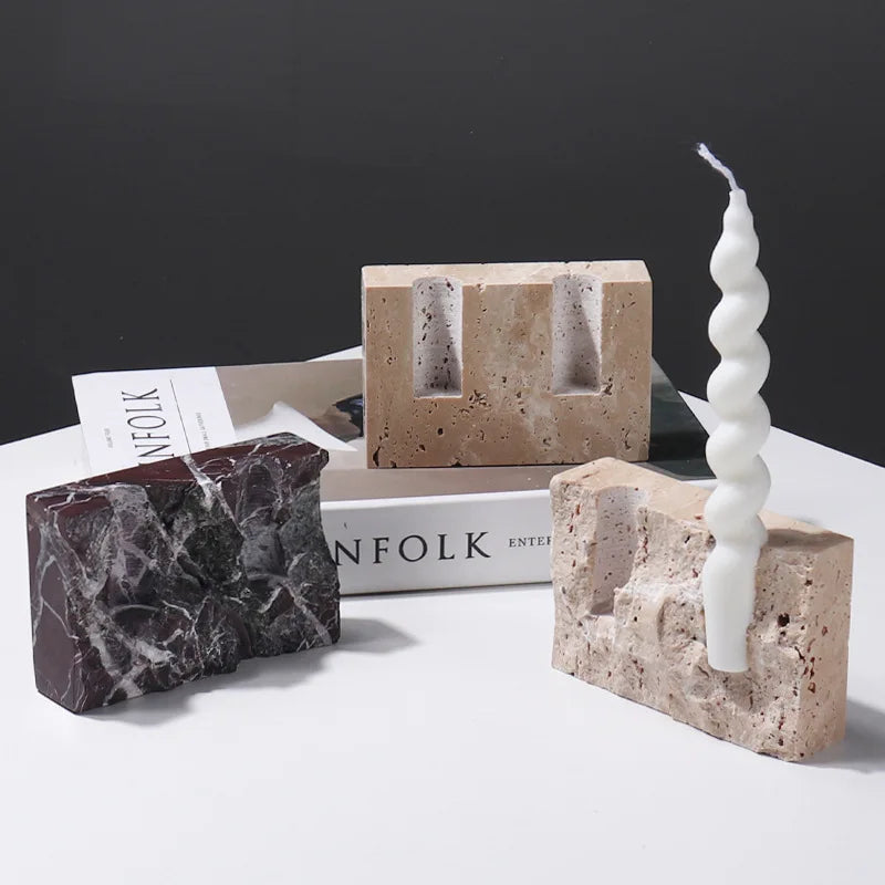 Brutalist candle holder with marble or travertine, anti-slip padding for stability.