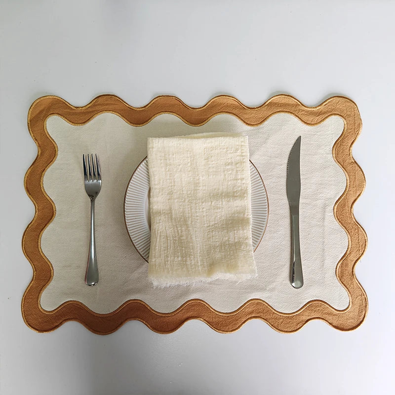 Image of the Paloma Placemat featuring a rectangular shape with a charming scalloped edge, designed for home décor enthusiasts. Made from a durable cotton double layer, it measures 35 x 50 cm and is available in four stylish colorways. Ideal for decorating dining tables with elegance and sophistication.