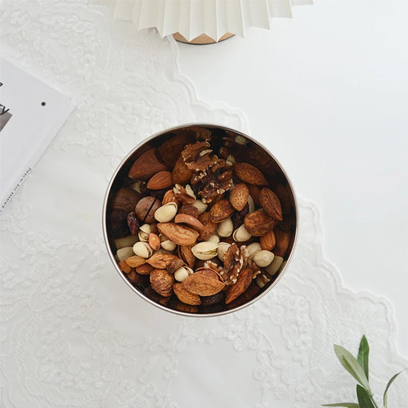 Eddard Serving Bowl featuring a modern design with a sleek stainless steel bowl and a sturdy wooden base. Compact and stylish, this small serving bowl is perfect for home decor enthusiasts looking to add a chic touch to their kitchen or coffee table. Ideal for serving snacks, fruits, or side dishes.