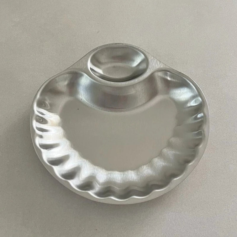 Elegant stainless steel Isadore Shell Tray with a unique shell design, featuring big and small sections for serving snacks, appetizers, or desserts. Perfect for entertaining, tableware with a vintage feel, and hosting in style. Compact yet versatile silver tray ideal for modern and sophisticated dining setups.