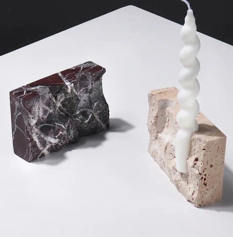 Brutalist candle holder with marble or travertine, anti-slip padding for stability.