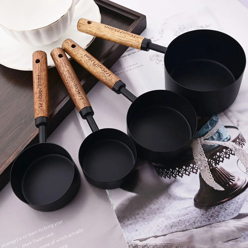 Stylish Lydia Measuring Cup & Spoon Set with wooden handles and stainless steel in black or gold, 8-piece set with engraved sizes for precise measurements, perfect for home décor enthusiasts and functional kitchen style.