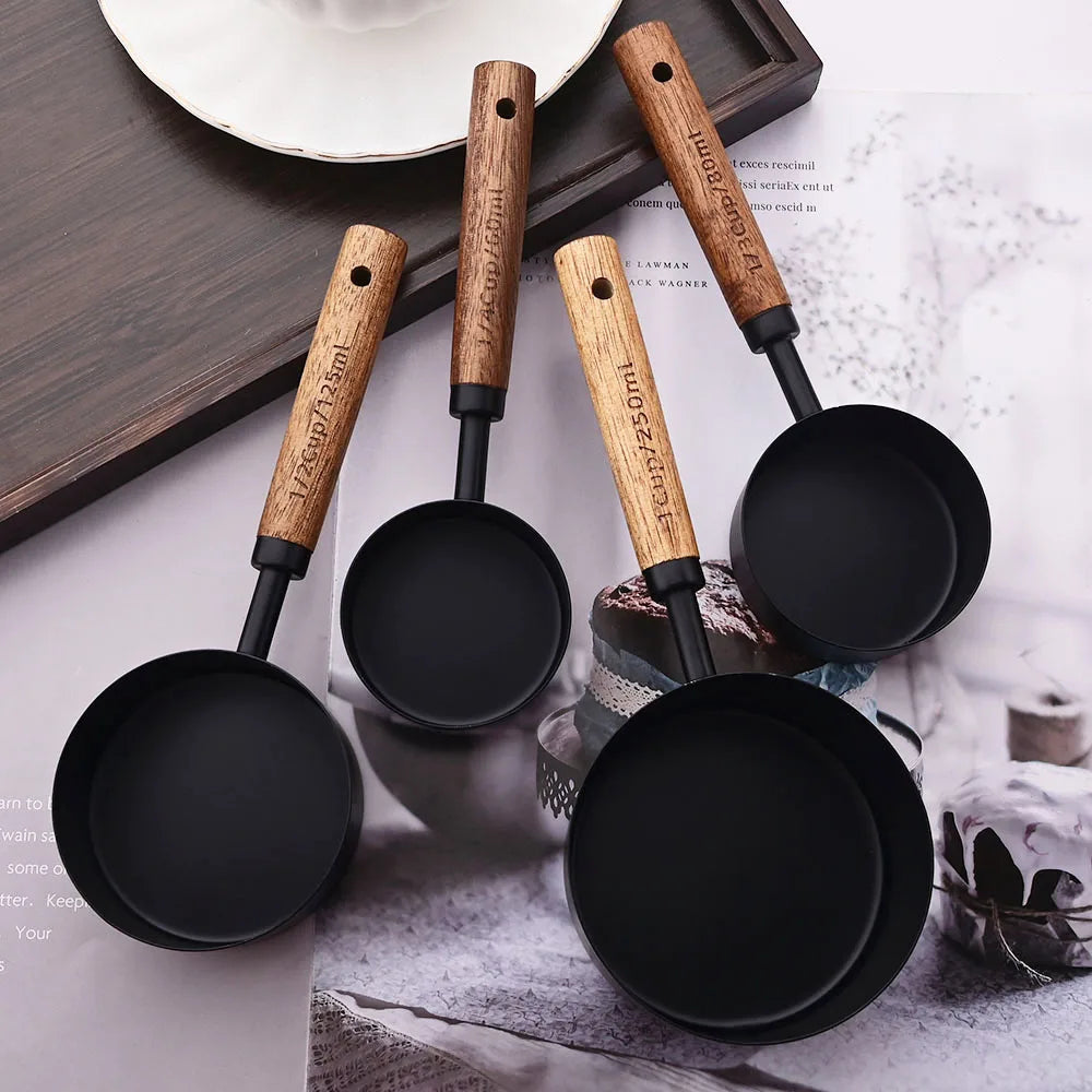 Stylish Lydia Measuring Cup & Spoon Set with wooden handles and stainless steel in black or gold, 8-piece set with engraved sizes for precise measurements, perfect for home décor enthusiasts and functional kitchen style.