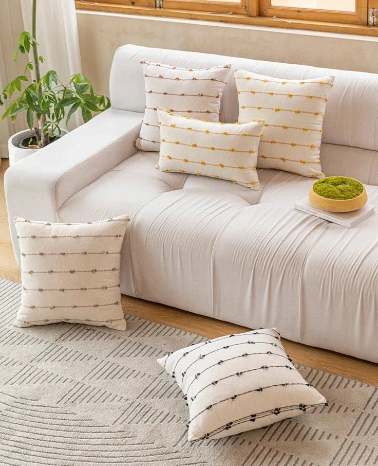 Elegant Irene Pillow Cover with cream neutral base and colored striped detailing, available in two sizes. Made from soft, high-quality cotton. Ideal for home decor enthusiasts, perfect for adding style to living rooms and bedrooms. Does not include filler.