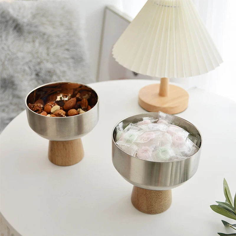 Eddard Serving Bowl featuring a modern design with a sleek stainless steel bowl and a sturdy wooden base. Compact and stylish, this small serving bowl is perfect for home decor enthusiasts looking to add a chic touch to their kitchen or coffee table. Ideal for serving snacks, fruits, or side dishes.