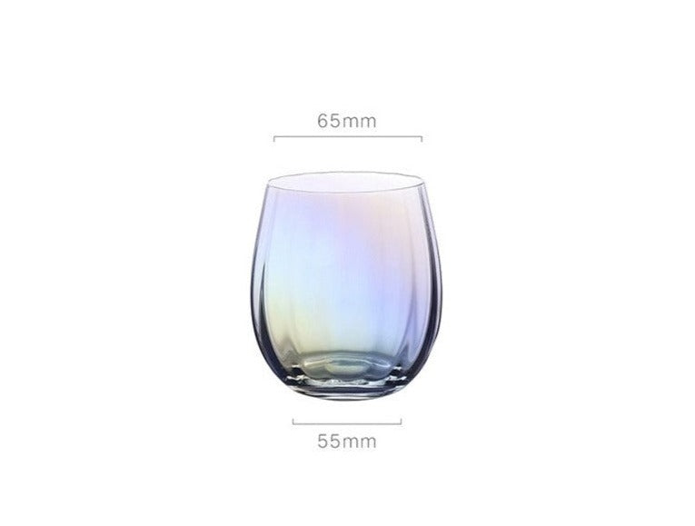 A collection of iridescent glassware from Domus Forge, featuring wine glasses, champagne coupes, decanters, and highball glasses in pastel gradient hues.