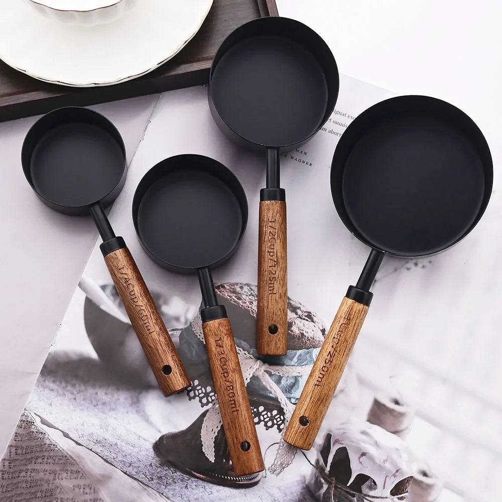 Stylish Lydia Measuring Cup & Spoon Set with wooden handles and stainless steel in black or gold, 8-piece set with engraved sizes for precise measurements, perfect for home décor enthusiasts and functional kitchen style.