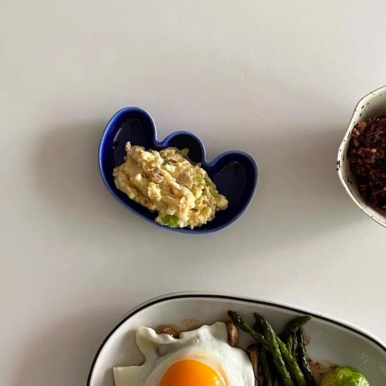 Handmade ceramic Rhett Dipping Dishes in bold vibrant colors, perfect for dipping and small bites. Four unique shapes provide versatility in presentation. Ideal for creating a mise en place. Shop now for artisanal charm in your dining experience.