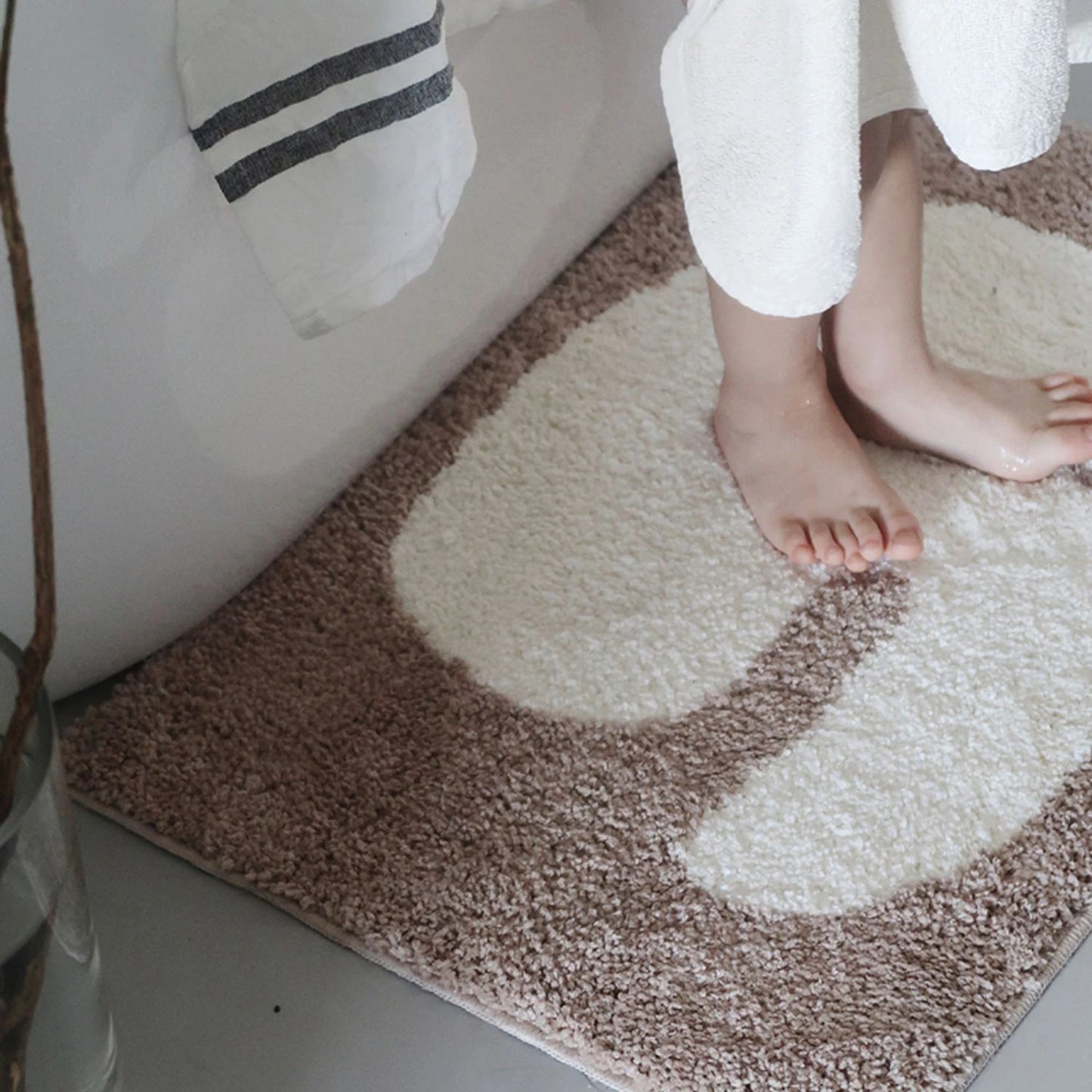 Oaklee Bath Mat featuring a plush, soft texture in various graphic styles and colors. Made from absorbent polyester with anti-slip backing, this minimalistic bath mat enhances bathroom décor while providing comfort and safety. Ideal for home décor enthusiasts seeking both style and functionality for their bathroom floor.