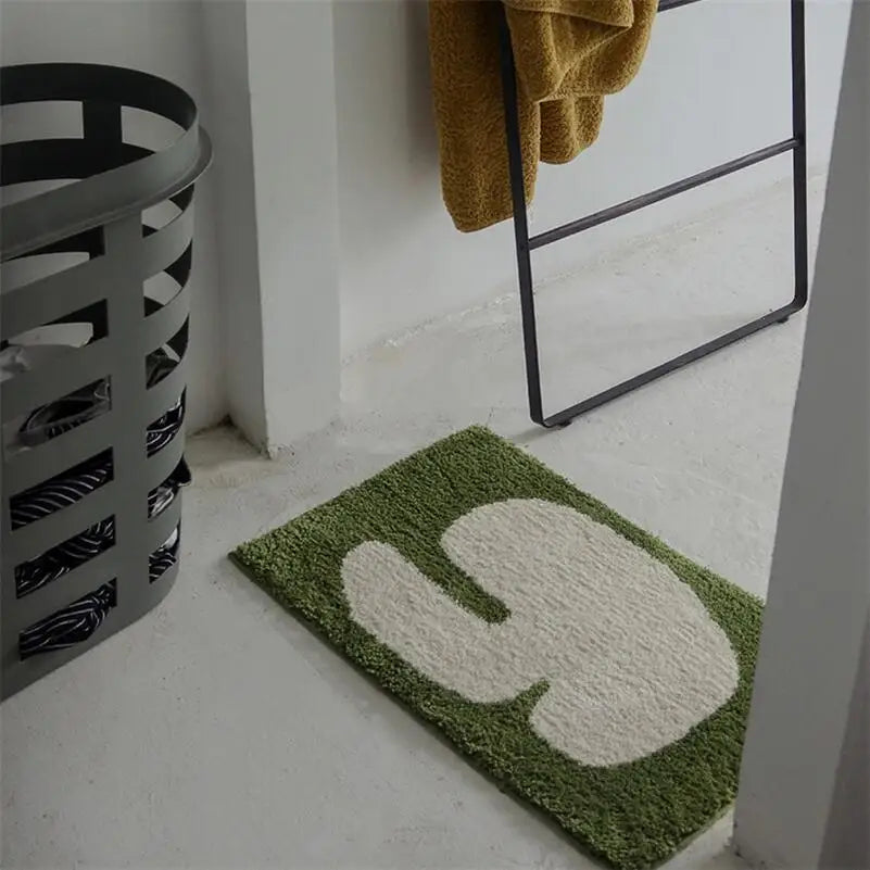Oaklee Bath Mat featuring a plush, soft texture in various graphic styles and colors. Made from absorbent polyester with anti-slip backing, this minimalistic bath mat enhances bathroom décor while providing comfort and safety. Ideal for home décor enthusiasts seeking both style and functionality for their bathroom floor.