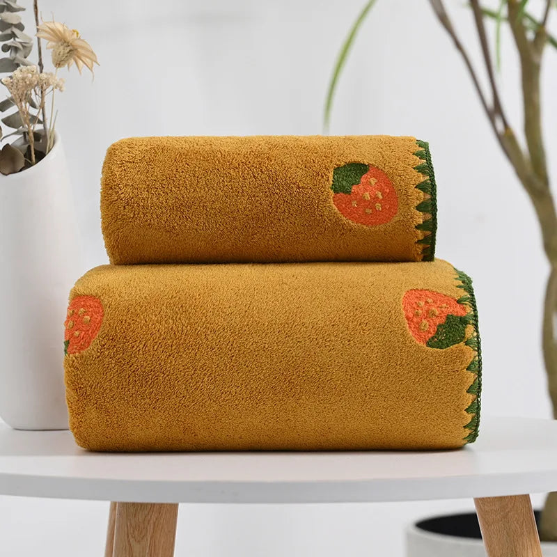Effie Towel collection: bath and hand towels with embroidered fruit motifs, velvet feel, warm colorways, polyester and combed cotton.