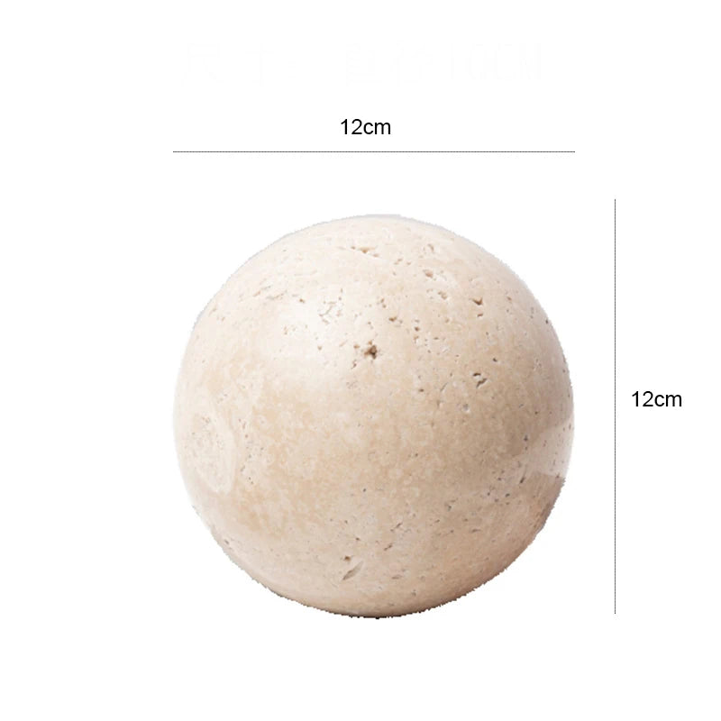 A creamy neutral marble sphere with a subtly textured finish, the Zella Stone Sphere has a simple, stylish design with a flat side for stability. Available in three sizes, this decorative stone sphere adds a refined touch to any space, ideal for home décor enthusiasts looking to enhance tabletops, shelves, or consoles with elegant and versatile decor accents.