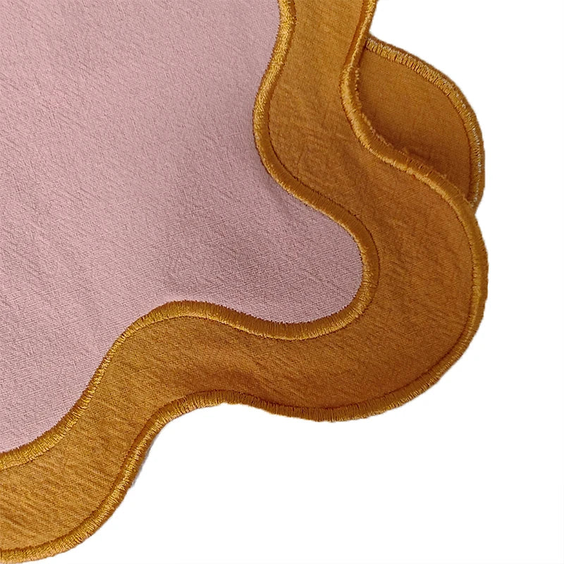 Image of the Paloma Placemat featuring a rectangular shape with a charming scalloped edge, designed for home décor enthusiasts. Made from a durable cotton double layer, it measures 35 x 50 cm and is available in four stylish colorways. Ideal for decorating dining tables with elegance and sophistication.