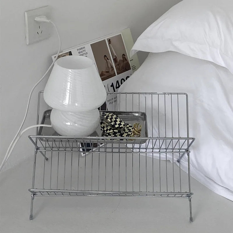Image of the Elli Rack, a versatile Stainless Steel Magazine and Kitchen Rack in a sleek silver finish. Modern, simple design suitable for various uses in the kitchen or living spaces, adding contemporary elegance to your home.