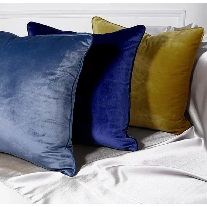 A collection of Bernadette Pillow Covers in various sizes and deep jewel tones, each crafted with a luxurious velvet feel. Made from 100% polyester, these pillow covers offer a rich and sophisticated look, perfect for home décor enthusiasts. Displayed on a sofa, the covers showcase their vibrant colorways and soft texture, ideal for adding elegance and comfort to any room. Pillow inserts are not included, allowing for customizable use and styling.