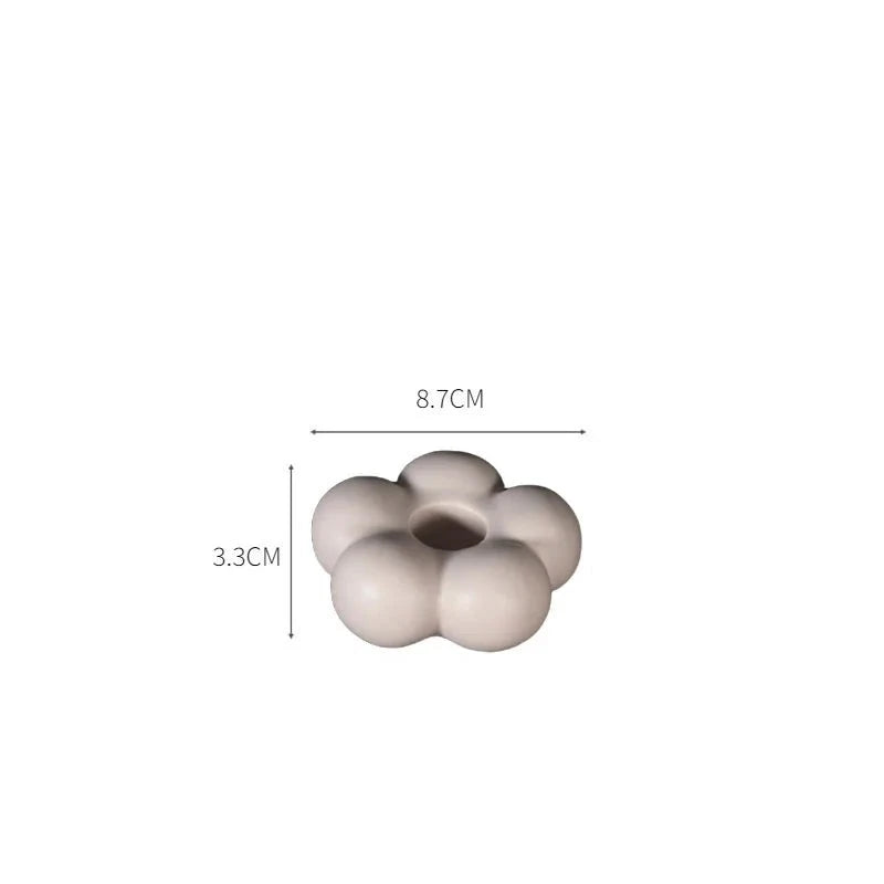 Modern ceramic Uchi candle holder in flower shape, available in various colorways, perfect for small or large candles.