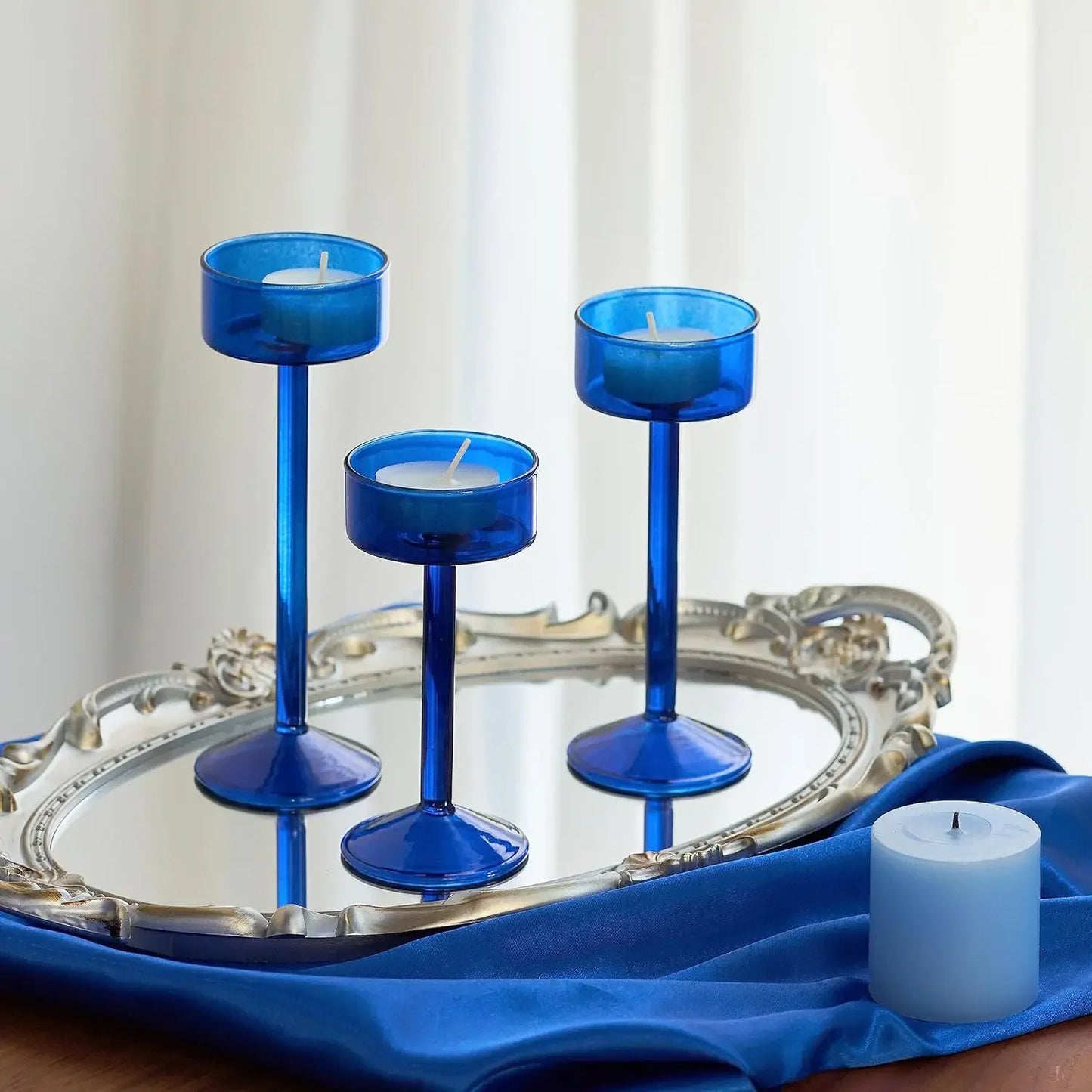 Kiu Candle Holder – set of three modern tea light holders in varying heights and colorways, perfect for creating a sleek, elegant centerpiece on tables, shelves, or mantels.