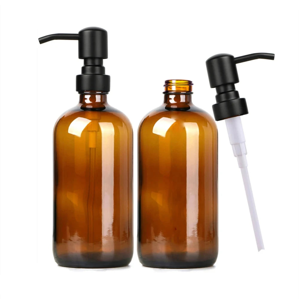 A set of two amber glass soap dispensers, each with a 16 oz capacity, featuring a choice of silver or black stainless steel pumps. Includes six printed labels for easy identification. Ideal for home décor enthusiasts, this reusable and refillable set adds a stylish touch to kitchens and bathrooms.