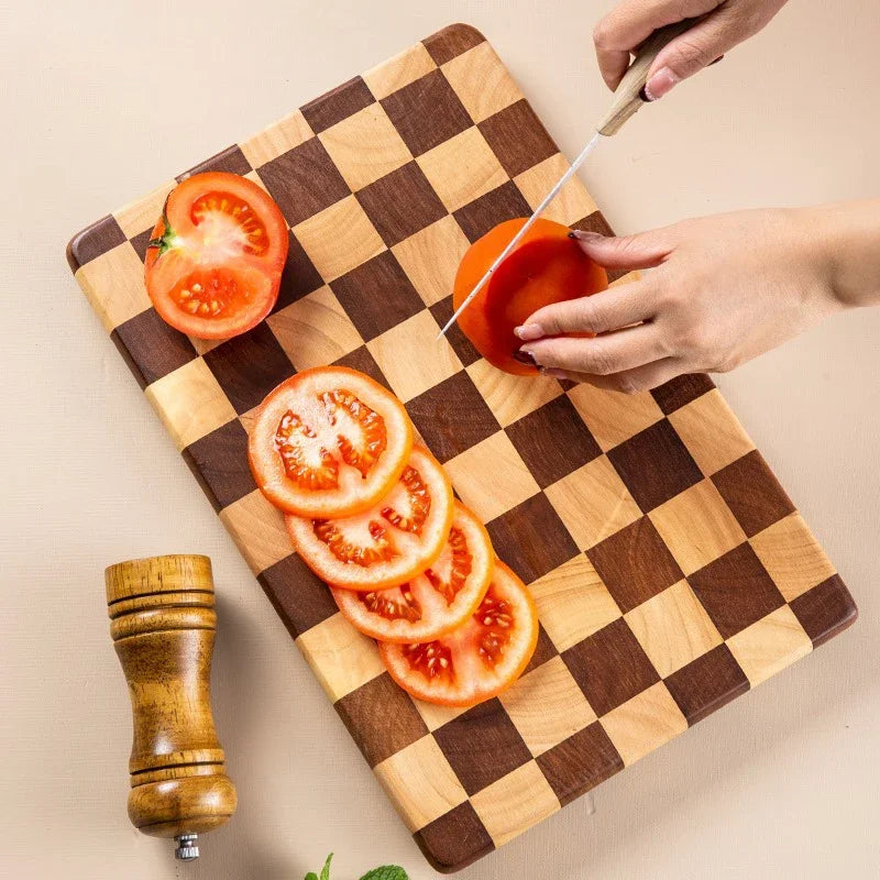 Rectangular wooden cutting board with a checkerboard pattern, available in three sizes. Features rounded corners and non-slip rubber feet, used for both meal prep and serving as a cheese board or decorative kitchen display.