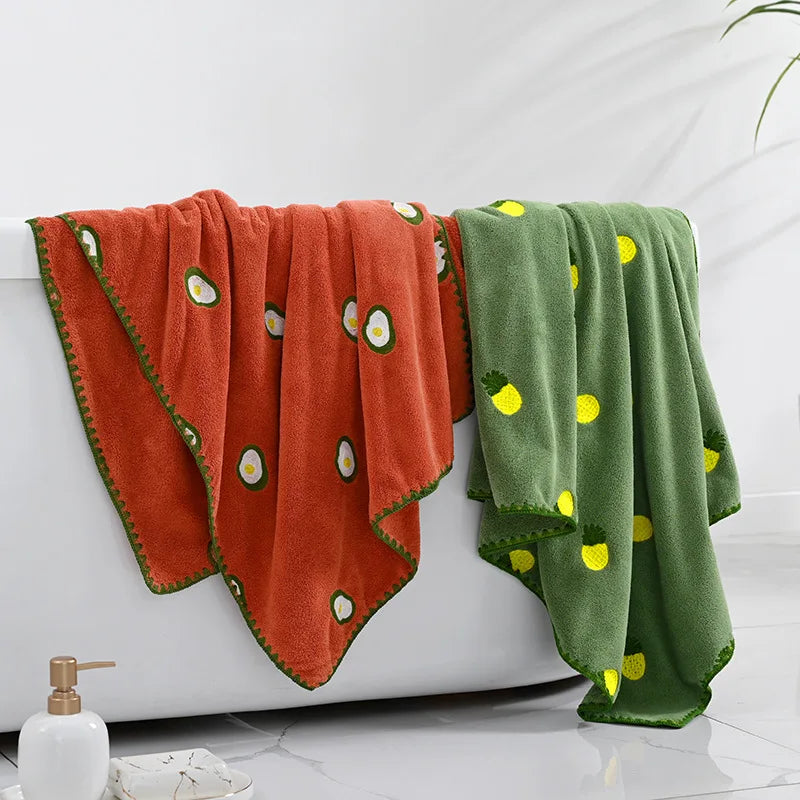 Effie Towel collection: bath and hand towels with embroidered fruit motifs, velvet feel, warm colorways, polyester and combed cotton.