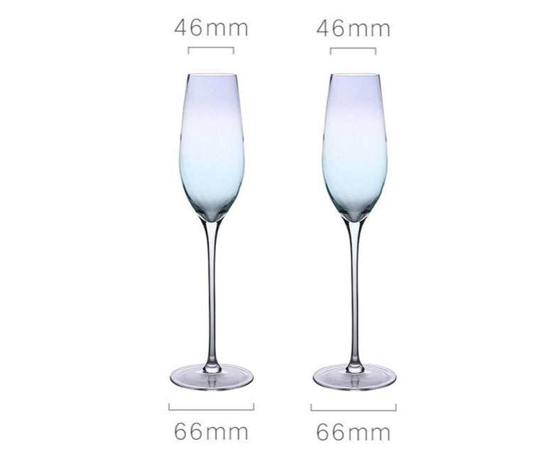 A collection of iridescent glassware from Domus Forge, featuring wine glasses, champagne coupes, decanters, and highball glasses in pastel gradient hues.