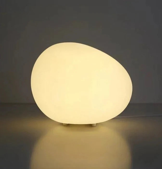 Isadora Table Lamp: Modern, minimalist lighting with cobblestone-inspired design. Three-color dimming. Shop now.