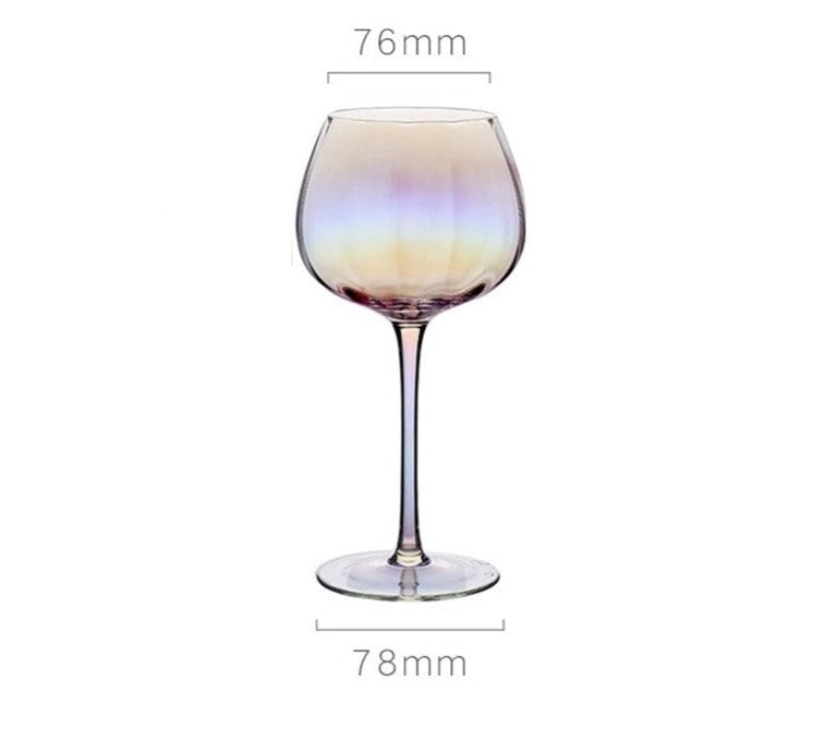 A collection of iridescent glassware from Domus Forge, featuring wine glasses, champagne coupes, decanters, and highball glasses in pastel gradient hues.