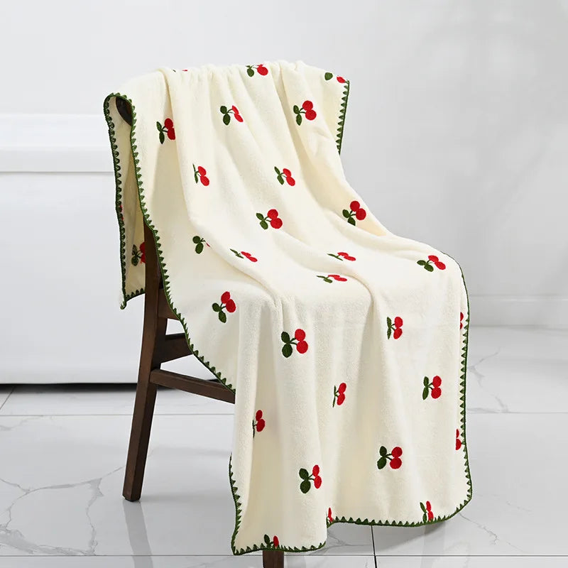 Effie Towel collection: bath and hand towels with embroidered fruit motifs, velvet feel, warm colorways, polyester and combed cotton.