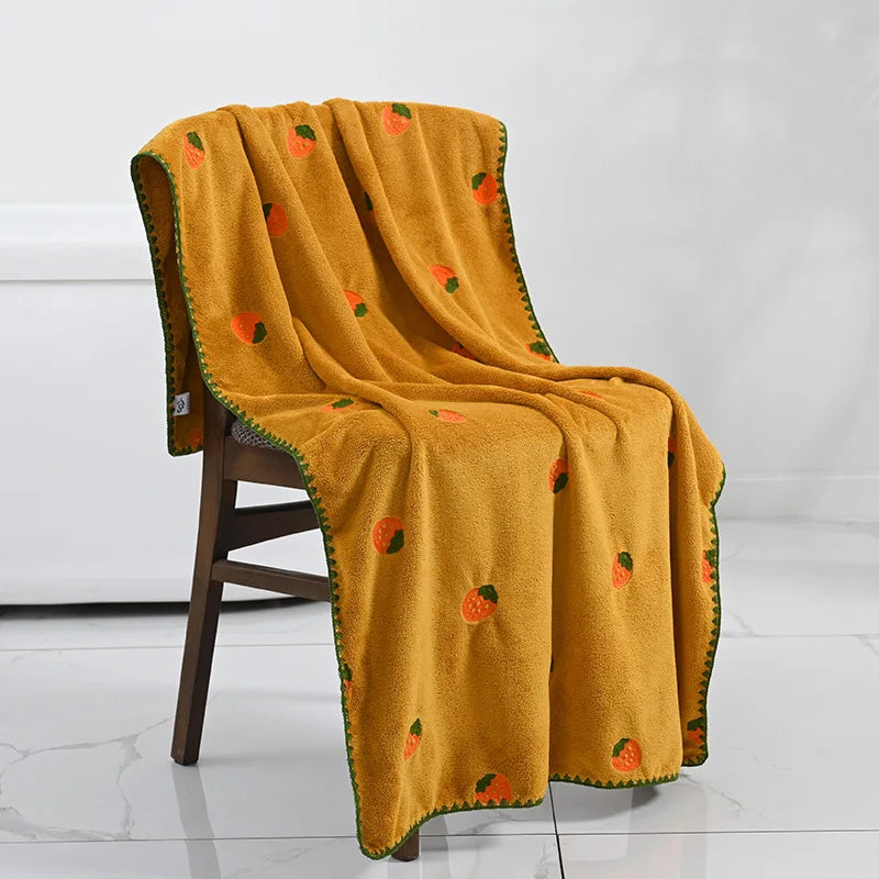 Effie Towel collection: bath and hand towels with embroidered fruit motifs, velvet feel, warm colorways, polyester and combed cotton.