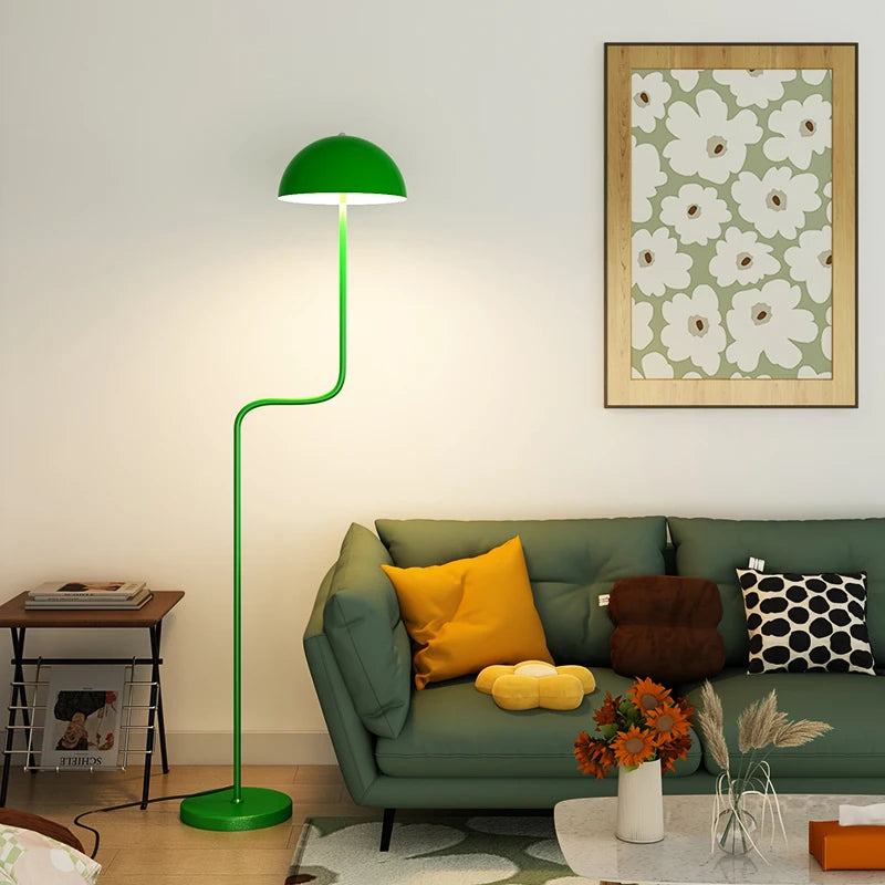 Image of the Tully Floor Lamp featuring a sleek, modern design with bright colorways. The lamp has a unique mushroom shape, made from durable metal, and includes an easy-to-use button switch. Perfect for home décor enthusiasts looking to add stylish accent lighting to their space.