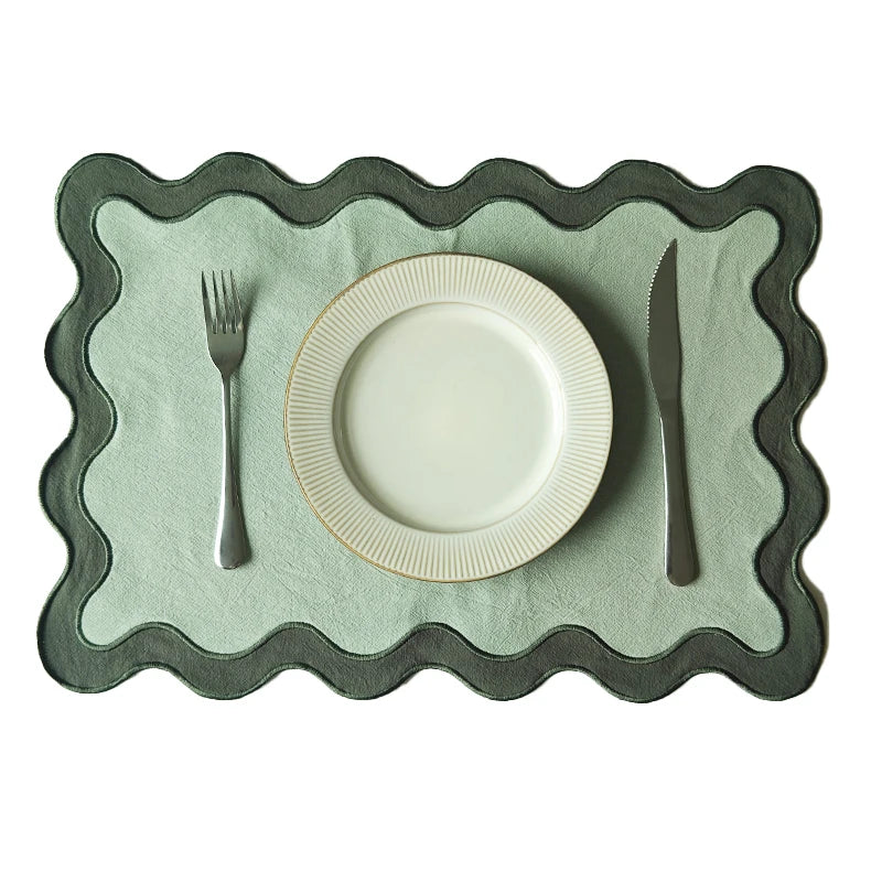 Image of the Paloma Placemat featuring a rectangular shape with a charming scalloped edge, designed for home décor enthusiasts. Made from a durable cotton double layer, it measures 35 x 50 cm and is available in four stylish colorways. Ideal for decorating dining tables with elegance and sophistication.