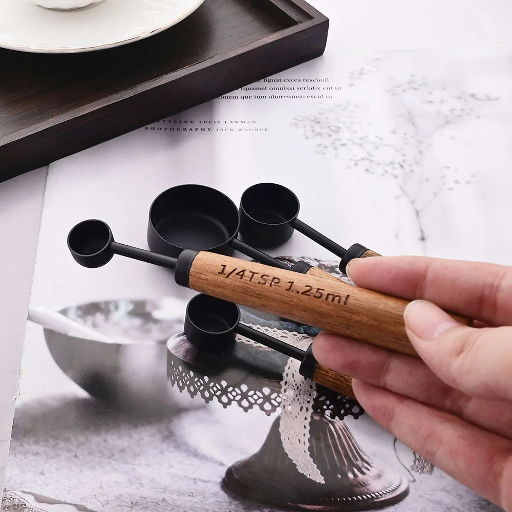 Stylish Lydia Measuring Cup & Spoon Set with wooden handles and stainless steel in black or gold, 8-piece set with engraved sizes for precise measurements, perfect for home décor enthusiasts and functional kitchen style.