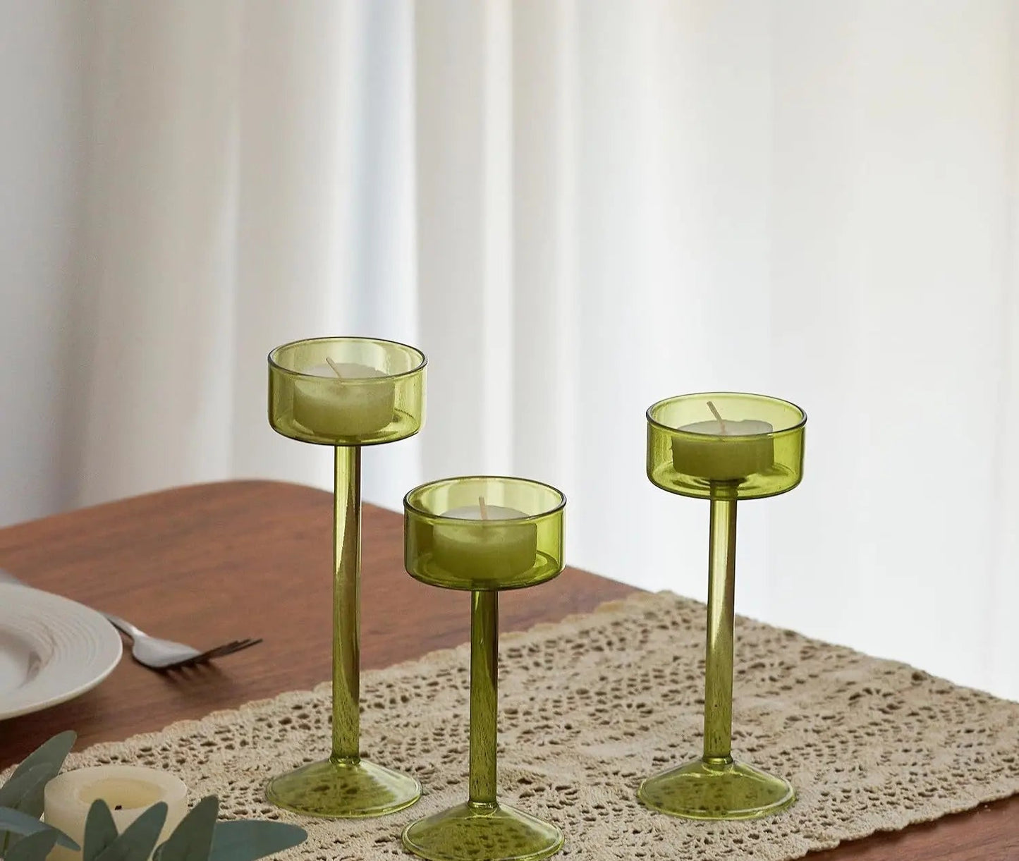 Kiu Candle Holder – set of three modern tea light holders in varying heights and colorways, perfect for creating a sleek, elegant centerpiece on tables, shelves, or mantels.