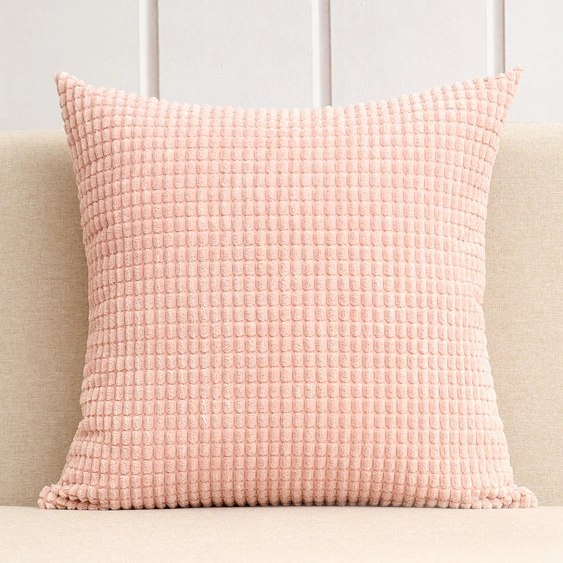 A stylish Warren Pillow Cover displayed on a couch, showcasing its soft corduroy corn grain texture. Available in various colorways and sizes, this square pillow cover adds warmth and elegance to any space. Ideal for home décor enthusiasts, it enhances living areas with a cozy, inviting touch. Please note that the pillow insert is not included.