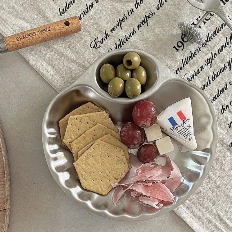 Elegant stainless steel Isadore Shell Tray with a unique shell design, featuring big and small sections for serving snacks, appetizers, or desserts. Perfect for entertaining, tableware with a vintage feel, and hosting in style. Compact yet versatile silver tray ideal for modern and sophisticated dining setups.