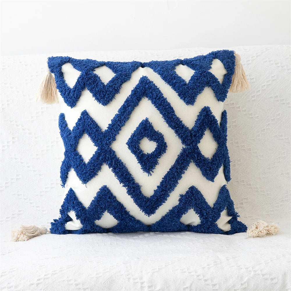 Photo displaying Zinnia Tufted Pillow Covers in vibrant colors with tufted details and charming tassels. Mix and match different patterns for a lively and sophisticated home decor. Inserts not included.
