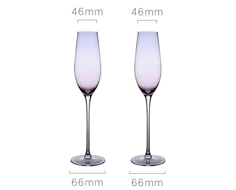 A collection of iridescent glassware from Domus Forge, featuring wine glasses, champagne coupes, decanters, and highball glasses in pastel gradient hues.