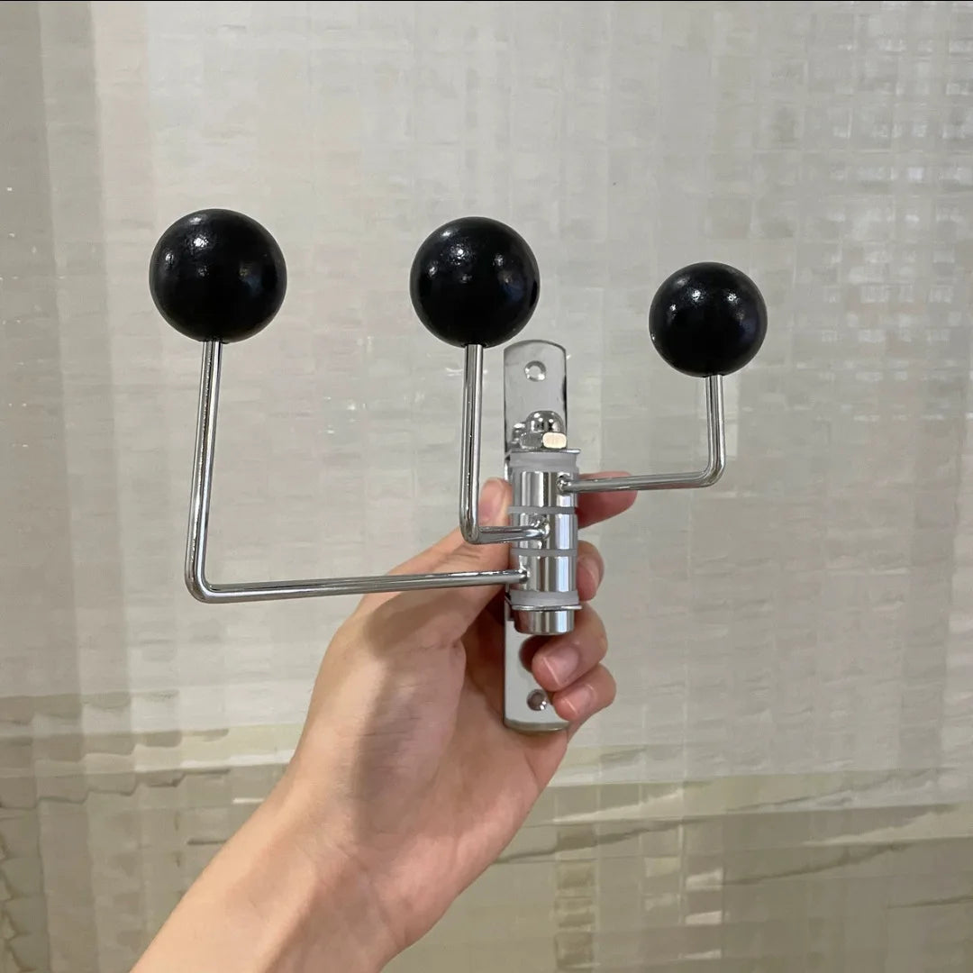 A silver wall-mounted rack with three hooks, each featuring bright wooden ball accents. The Randi Wall Rack has a modern yet vintage-inspired design, ideal for hanging towels or accessories in entryways, bathrooms, or bedrooms. Perfect for home decor enthusiasts seeking a stylish, space-saving storage solution.